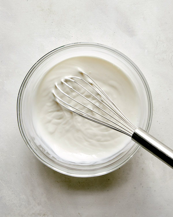 Whisking together ingredients to make buttermilk ranch. 