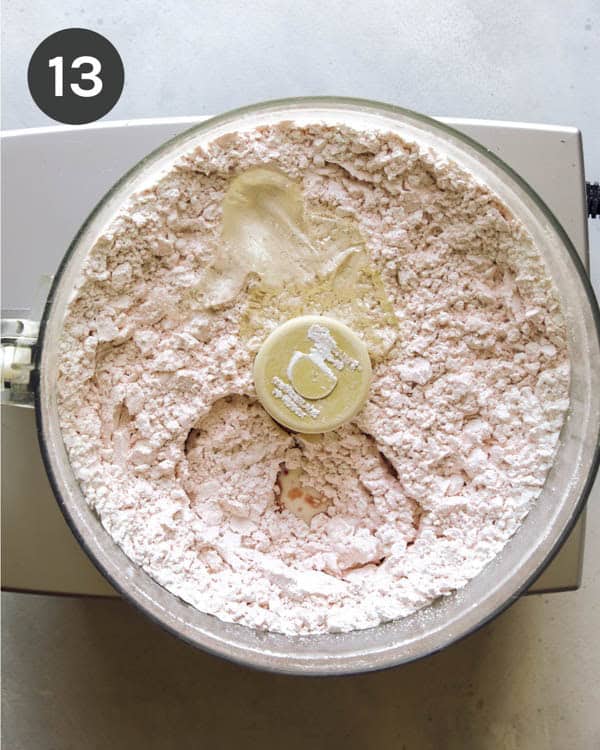 Strawberry icing being made in a food processor.