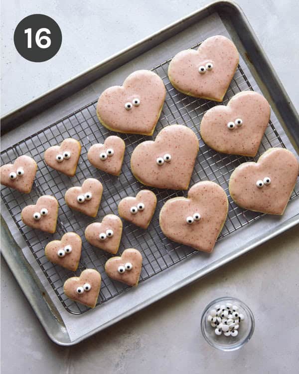 Decorating heart shaped valentines day cookies.