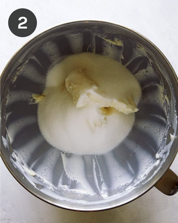 Butter and sugar being creamed in a stand mixer.