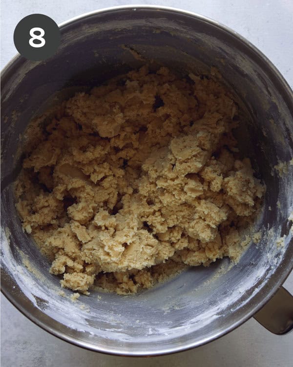 Cookie dough in the well of a stand mixer.