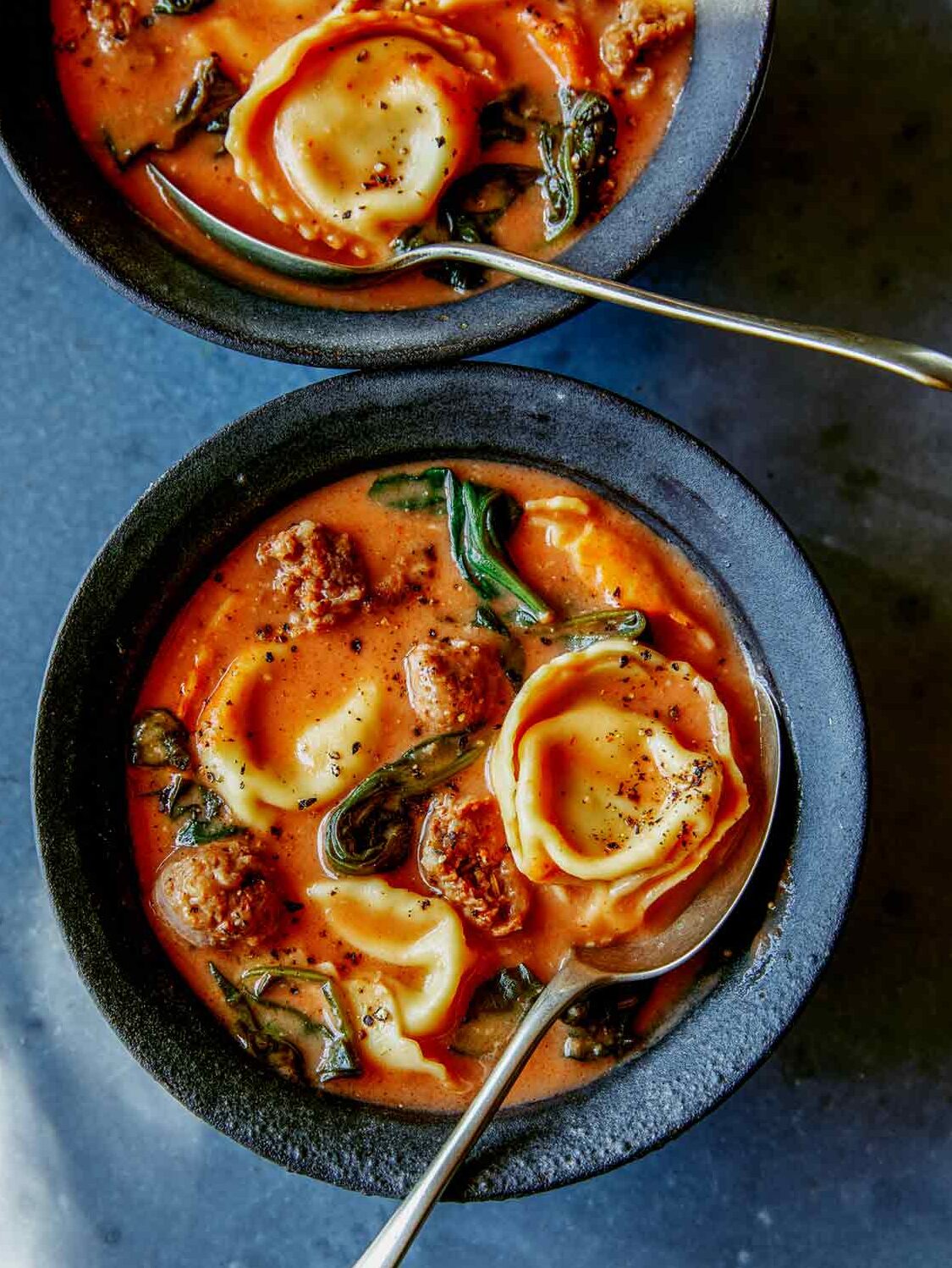 Creamy Tortellini Soup Recipe in a bowl with a spoon in it.