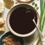 Teriyaki sauce recipe in a bowl with a spoon in it.