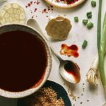 Teriyaki sauce in a bowl with ingredients around it.