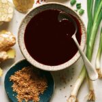 Teriyaki sauce recipe in a bowl with a spoon in it.