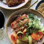 Teriyaki salmon recipe in two bowls with sesame seeds on the side.