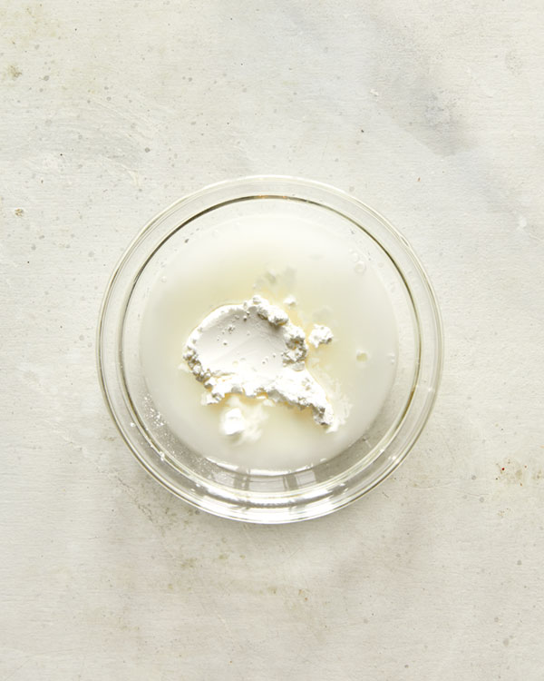 Cornstarch and water in a bowl for teriyaki sauce.