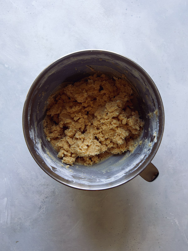 Cookie dough in a bowl being mixed. 