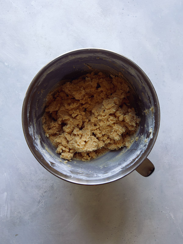 Cookie dough in a bowl being mixed.