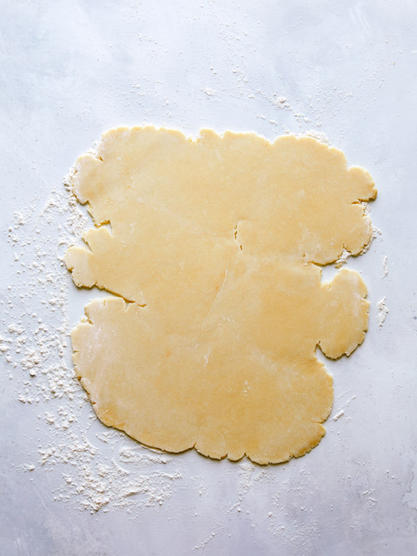 Cookie dough being rolled out to make Valentines day cookies.