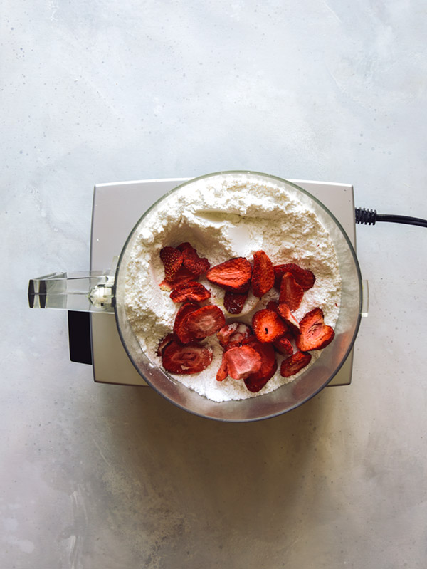 Freeze dried strawberries to make pink icing in a food processor.