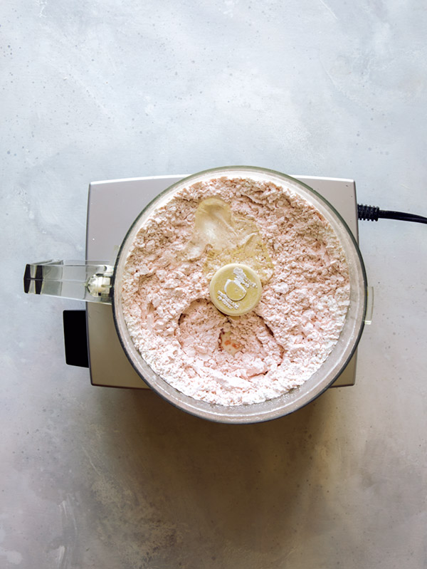 Strawberry icing being made in a food processor.