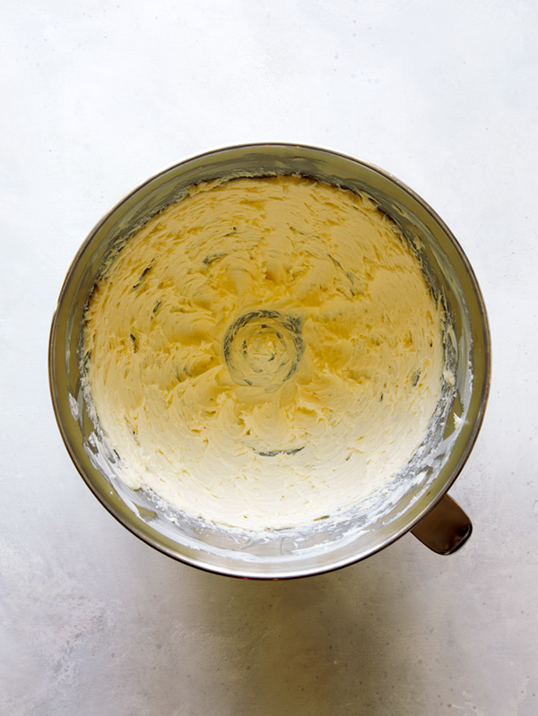 Butter being creamed in a stand mixer to make valentines day cookies.