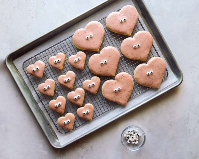 Decorating heart shaped valentines day cookies.