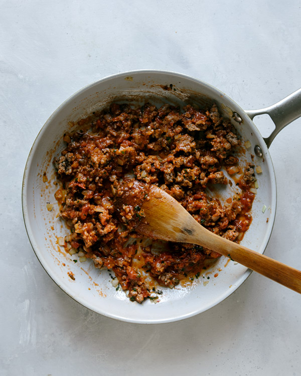 Turkey sausage with marinara sauce in a skillet. 