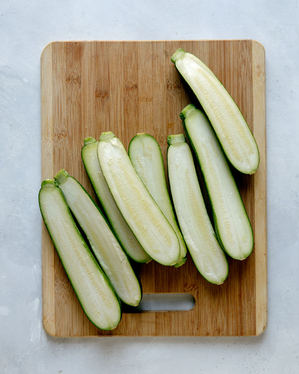 Zucchini sliced in half for zucchini boats. 