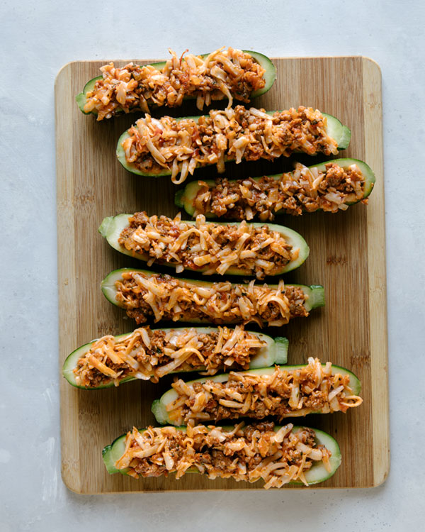 Zucchini boats stuffed and ready to be baked.