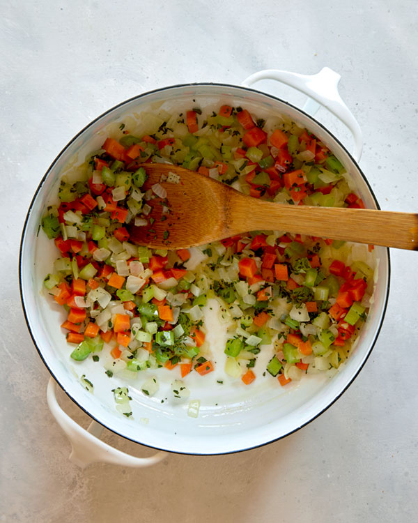 Vegetables in a pot with thyme and sage.