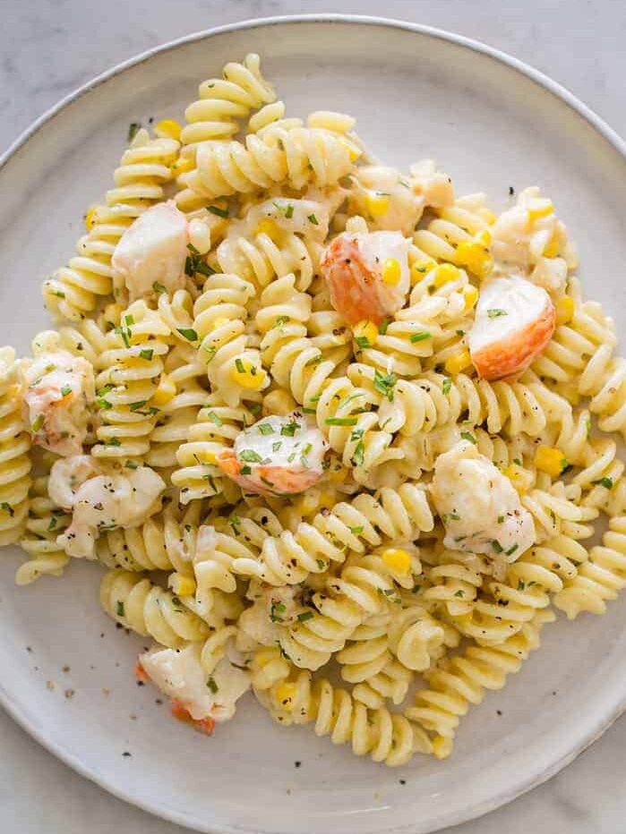 Lobster and corn pasta with white wine and tarragon cream sauce on a plate.
