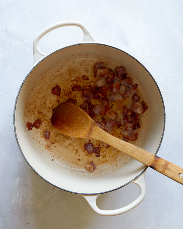 Bacon cooking in a pot for zuppa toscana. 