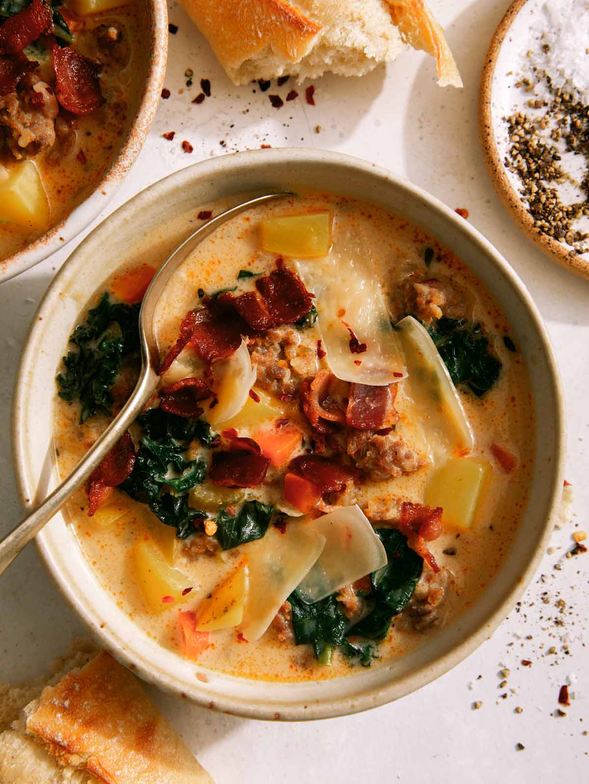 Zuppa toscana in a bowl with a spoon in it.
