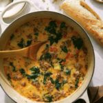 Zuppa Toscana in a pot with bread on the side.