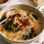 Zuppa toscana in a bowl with a spoon in it.