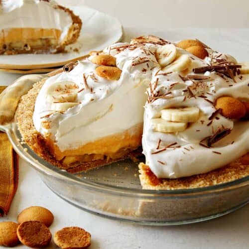 Banana cream pie recipe with a slice taken out.