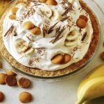 Banana cream pie recipe with bananas in the background.