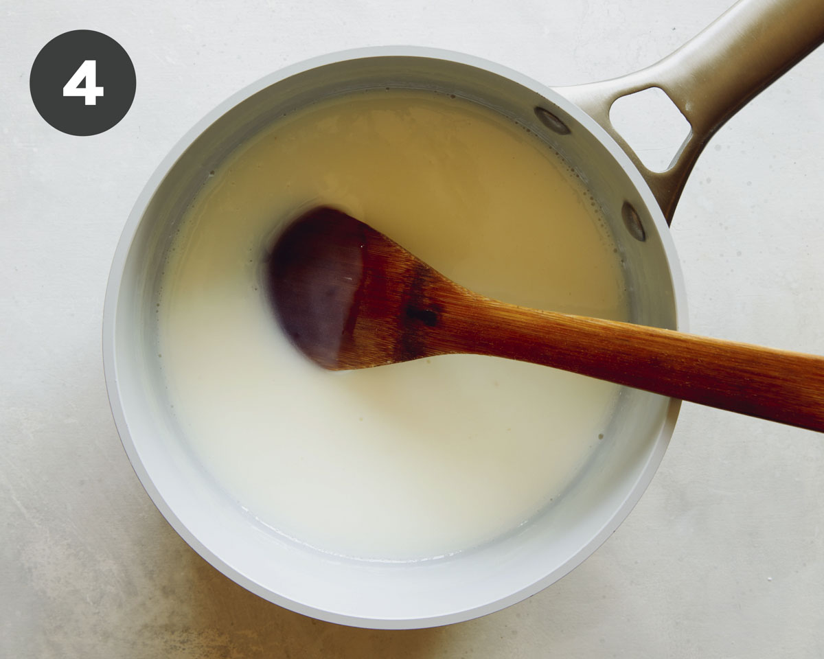 Making pudding a stock pot with a wooden spoon.
