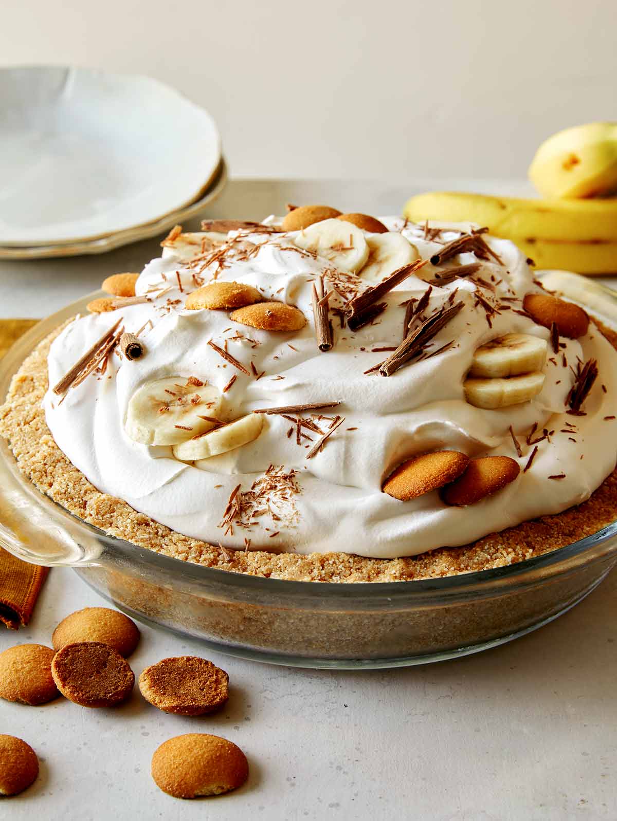 Banana cream pie recipe with bananas in the background. 