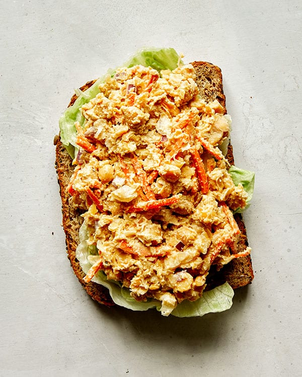 Making a chickpea salad sandwich.