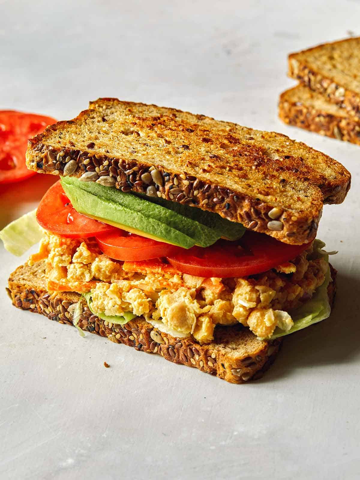 A whole chickpea sandwich with avocado. 