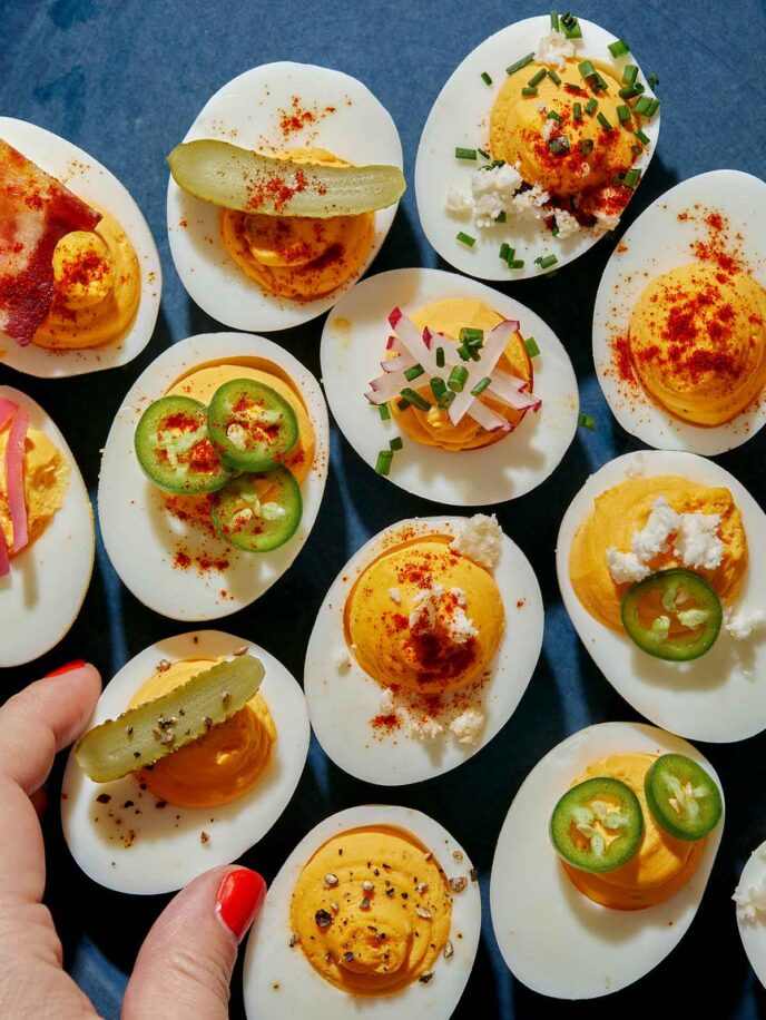 Deviled eggs being taken off a platter. 