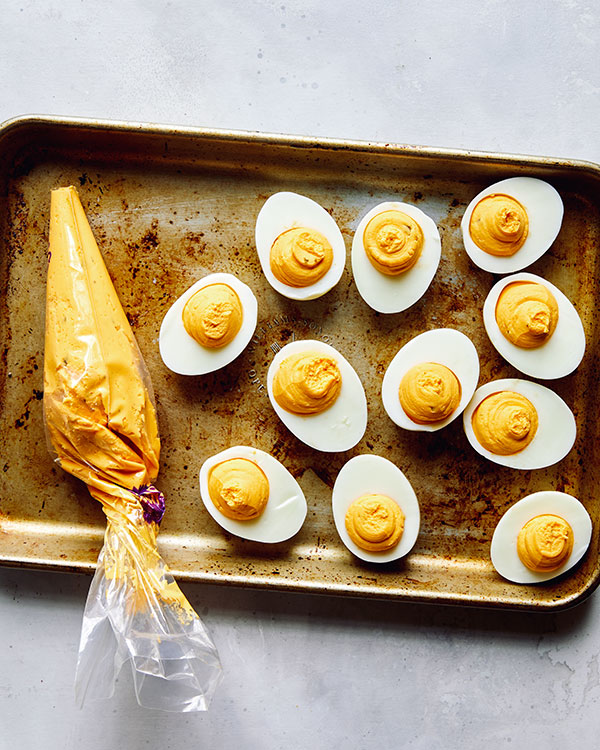 Deviled eggs being made and filled.