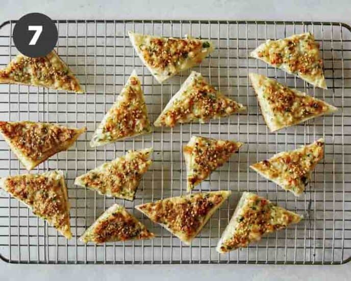 Shrimp toast triangles on a drying rack. 