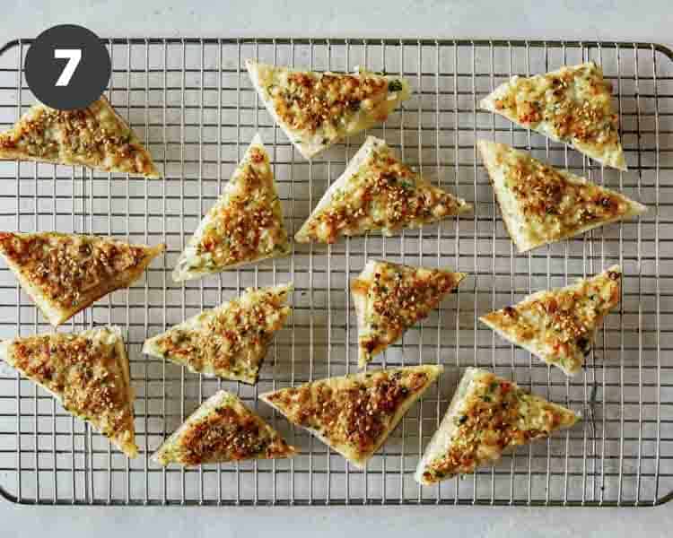 Shrimp toast triangles on a drying rack. 