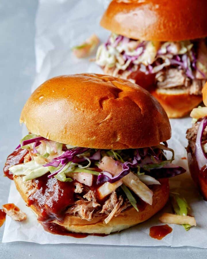 Slow Cooked Pulled Pork sandwiches on a surface.