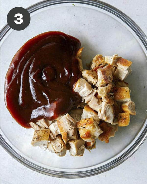 Chopped chicken and BBQ sauce in a bowl.