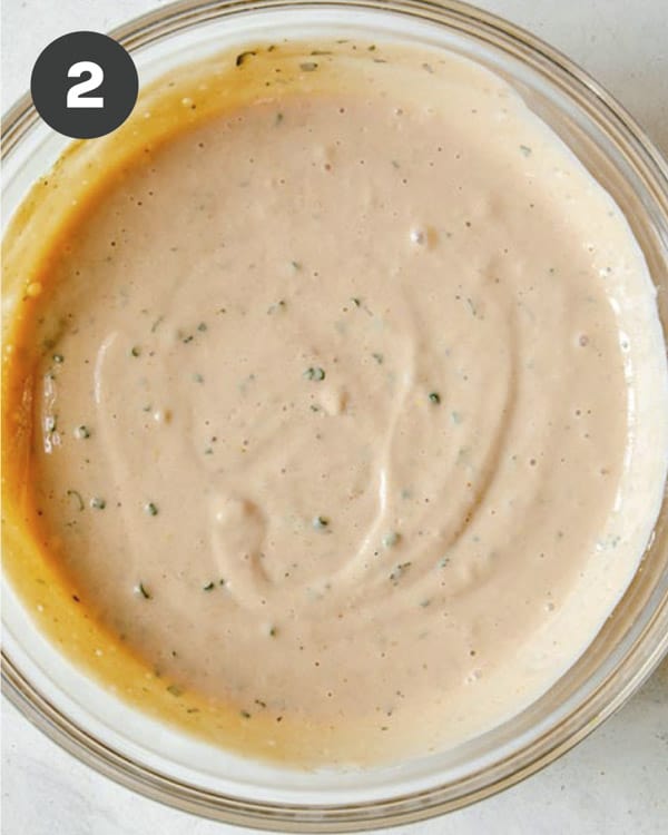 Combined ingredients in a bowl to make BBQ Yogurt Ranch Dressing.