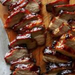 Char siu pork on a cutting board.