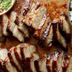 Char siu pork on a cutting board.