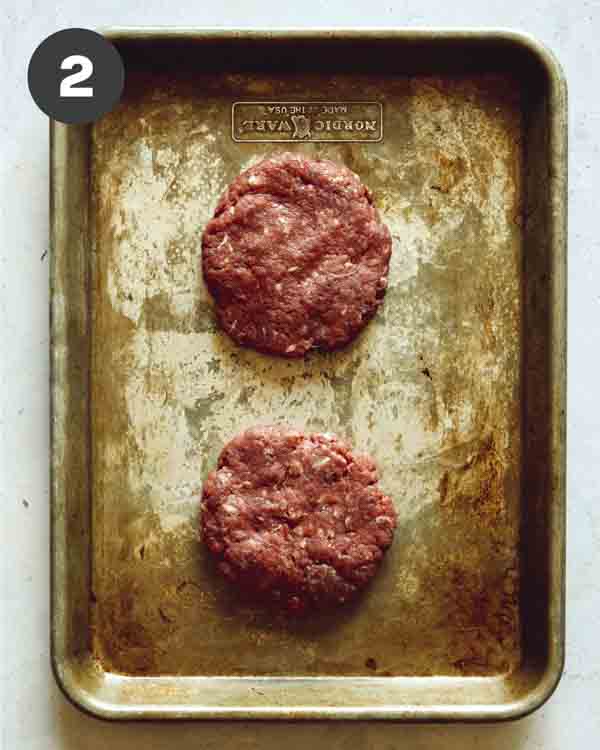 Hamburger patties formed on a tray. 