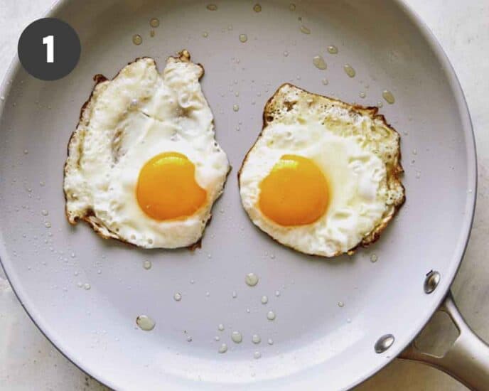 Fried egg in a skillet with oil.