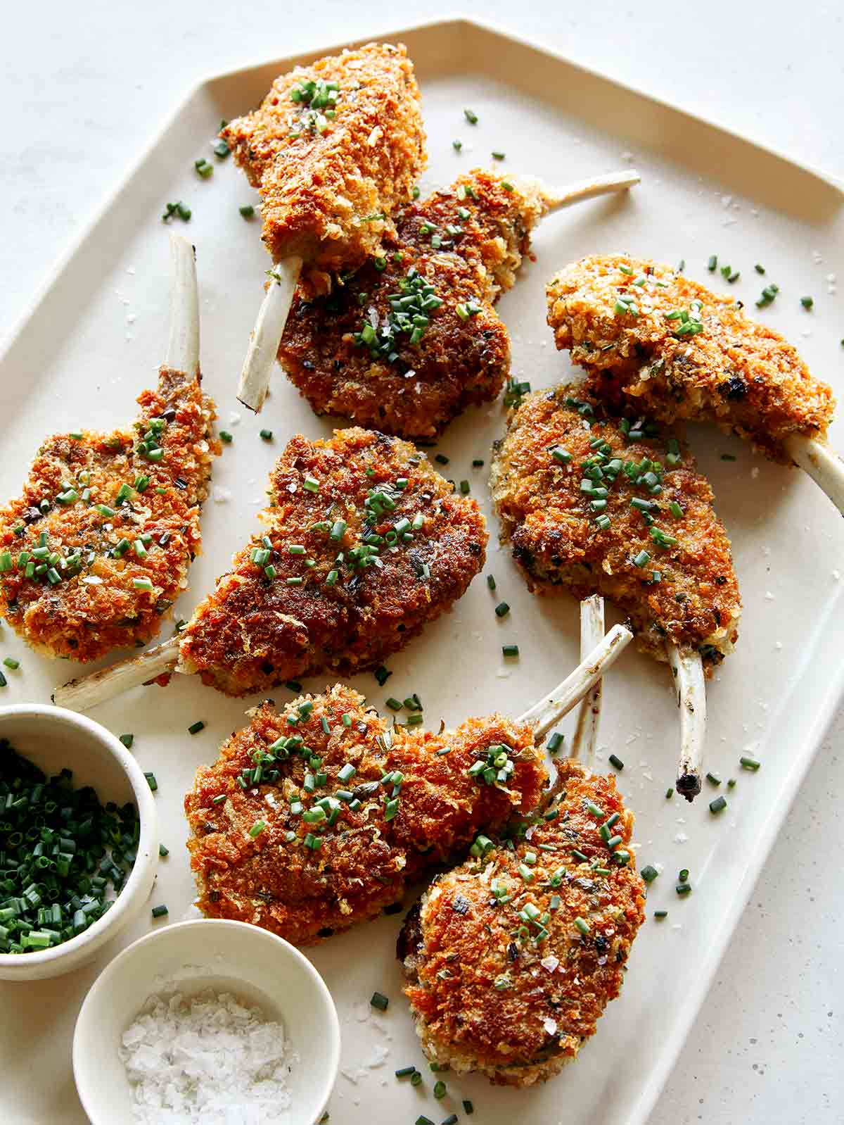 Panko crusted lamb chops on a plate. 