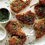 Panko crusted lamb chops with chives on top.