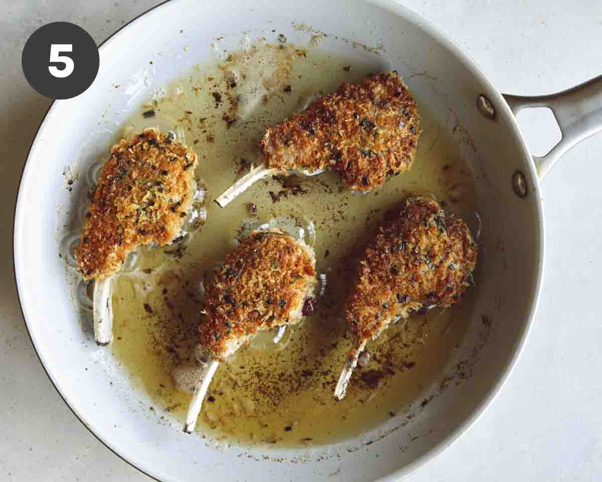 Panko crusted lamb chops searing in a pot.