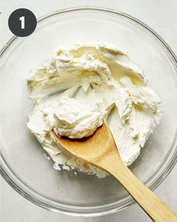Cream cheese with mayonnaise in a bowl mixed together.