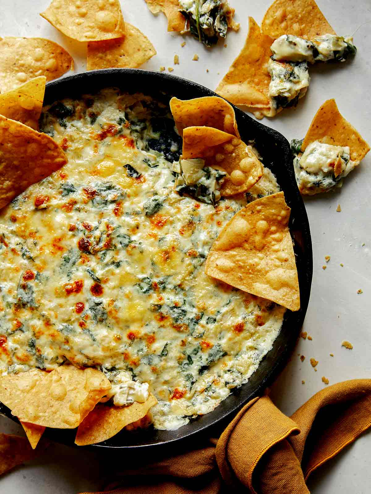 Spinach and artichoke dip in a skillet. 