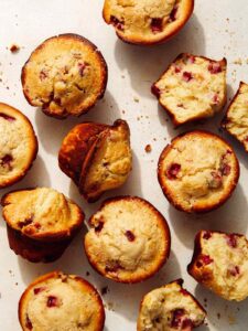 Freshly baked strawberry muffins on a counter.